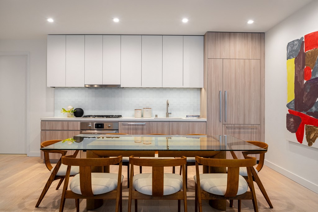 kitchen with light finishes and glass dining table
