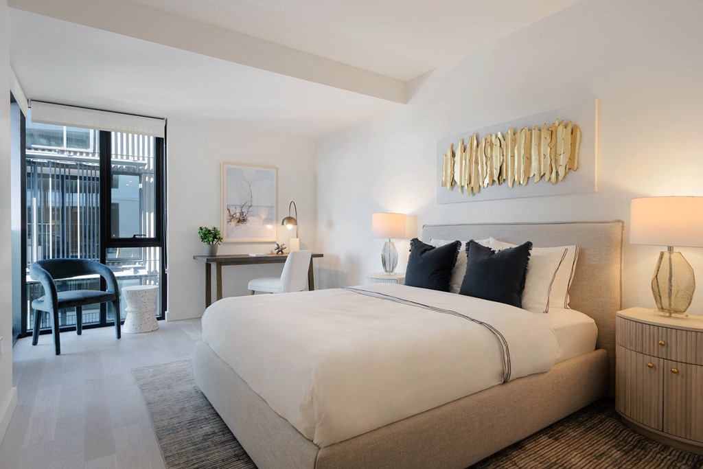 king sized bedroom with floor to ceiling window, private terrace or balcony and spacious floorplan with walk in closets