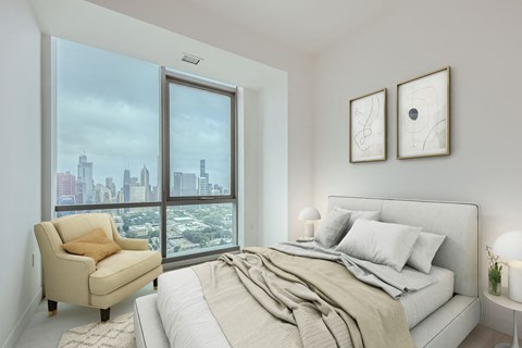 a bedroom with a bed and a large window