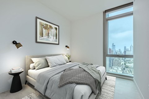 a bedroom with a bed and a large window