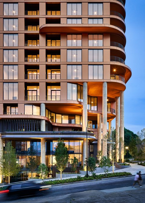 A tall building with a curved design and many windows is shown. at Stella at Star Metals in West Midtown, Atlanta