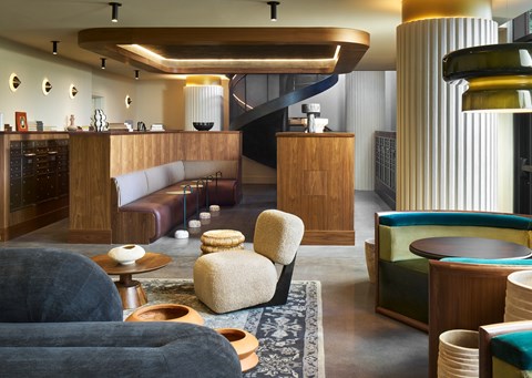 A modern living room with a grey sofa and a wooden coffee table at Stella at Star Metals in West Midtown, Atlanta.