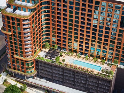 A tall building with a pool in the courtyard at Stella at Star Metals in West Midtown, Atlanta