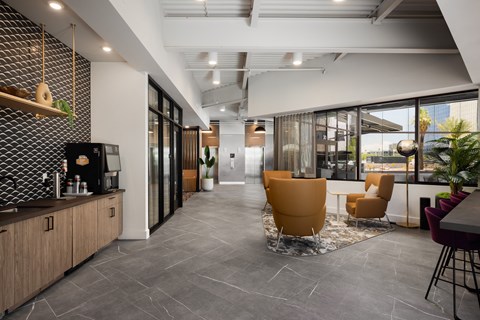 the lobby of a corporate office with a table and chairs