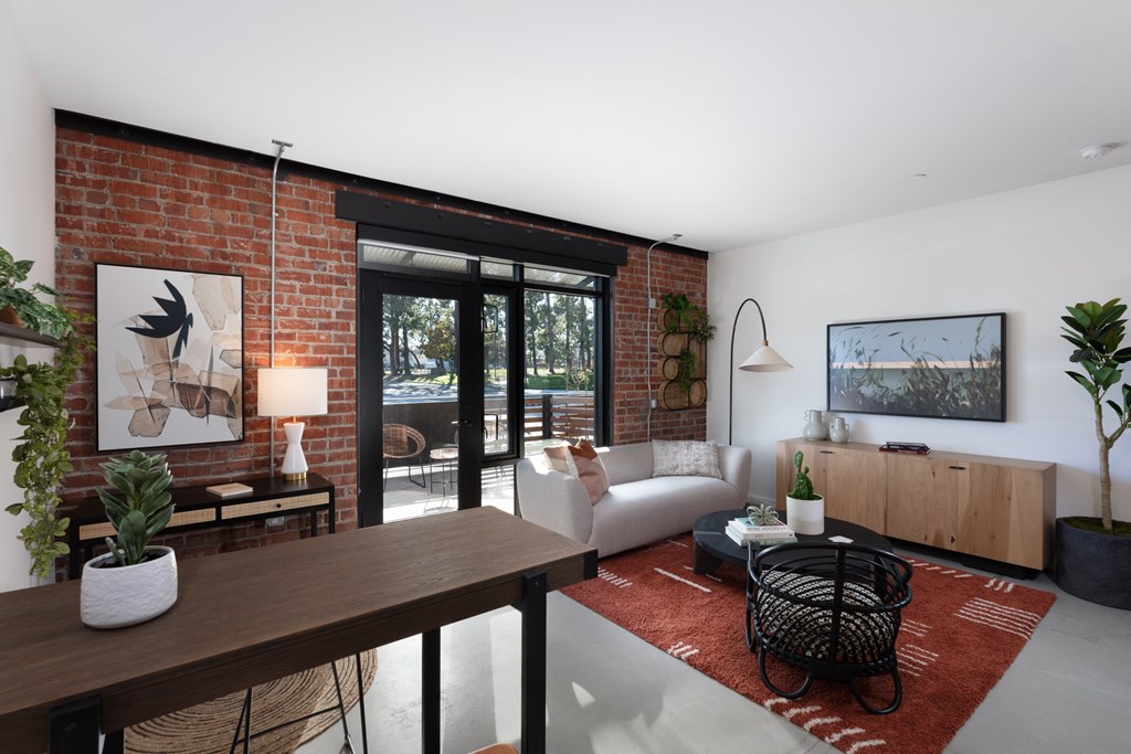 Exposed brick feature wall in living area at Star Harbor Apartments & Townhomes in Alameda, CA.