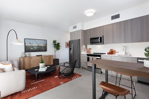A modern kitchen with a dining table and chairs.