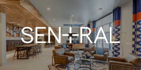 a living room with chairs and a table and a large window