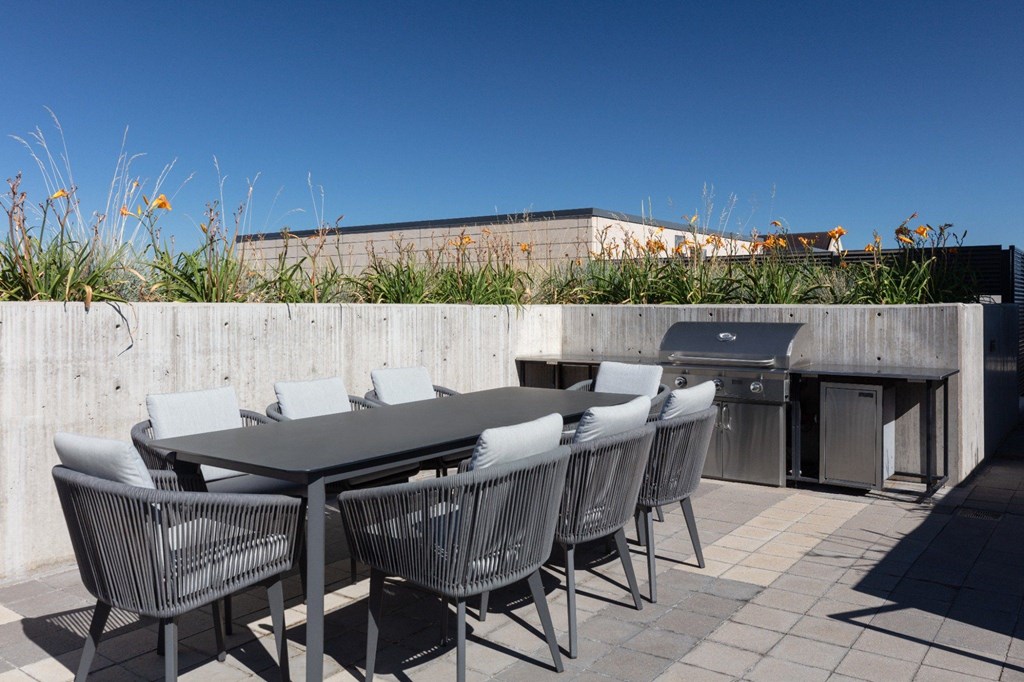 A table with chairs is set up on a patio.
