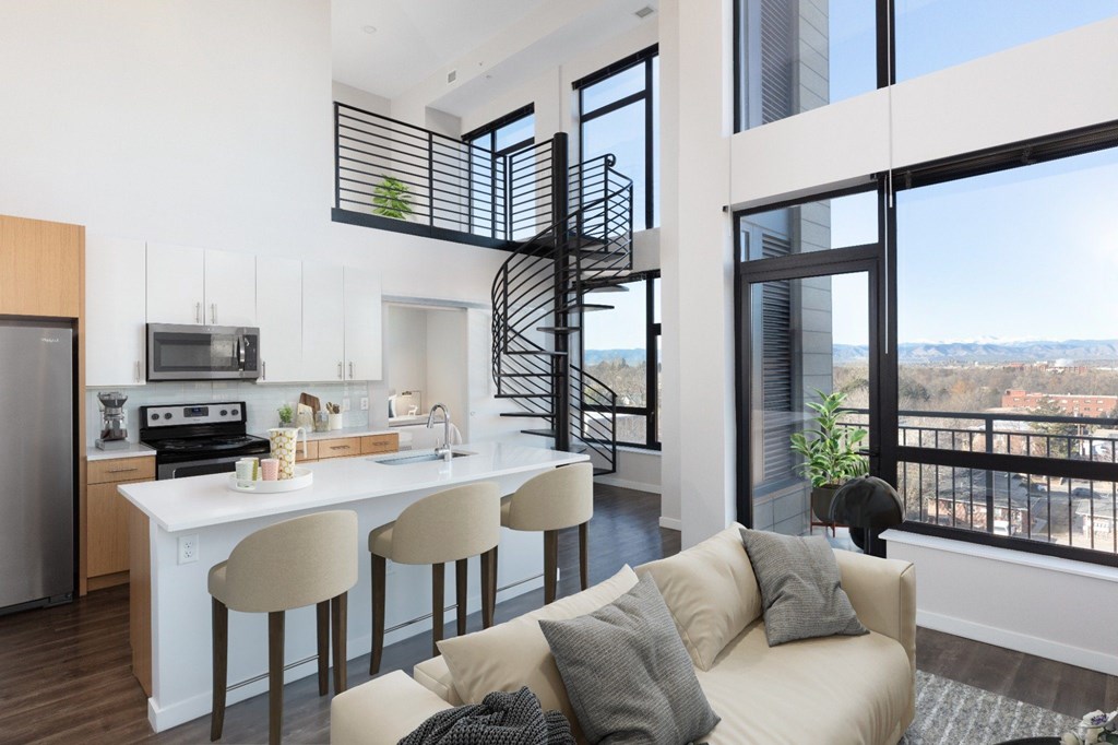 A modern kitchen with a spiral staircase in the middle.