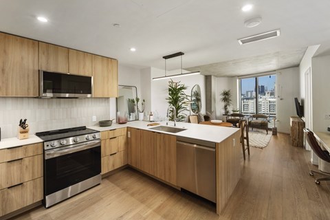 A modern kitchen with wooden cabinets and stainless steel appliances.