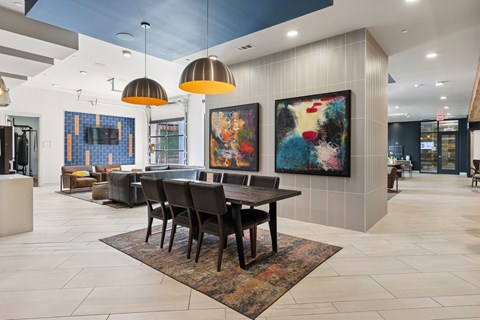 A modern dining room with a large painting on the wall.