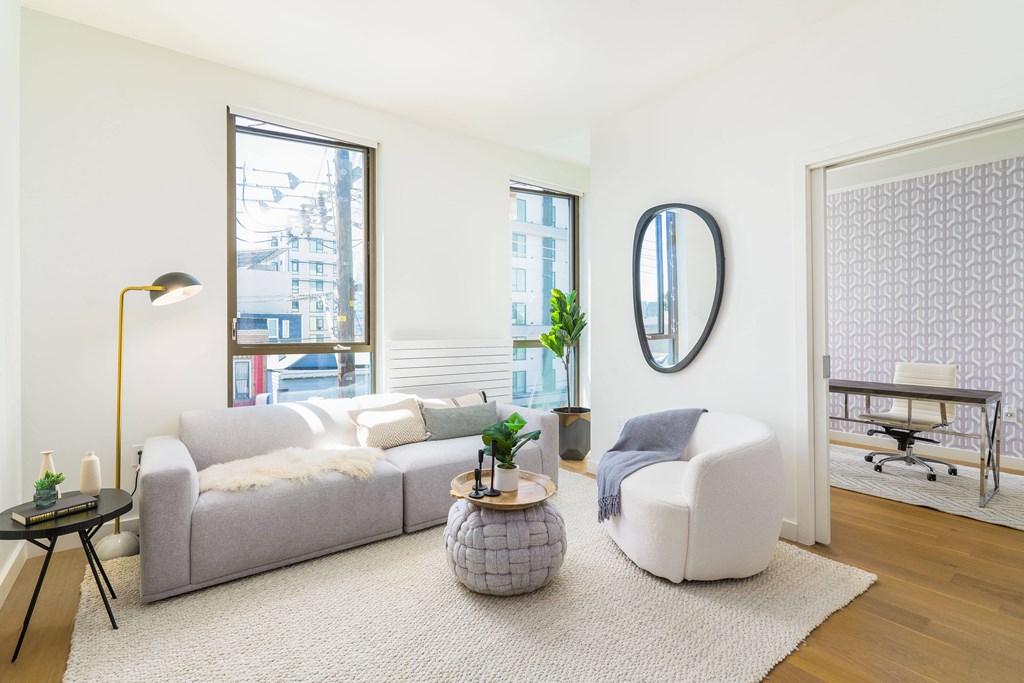 a living room with white walls and a gray couch