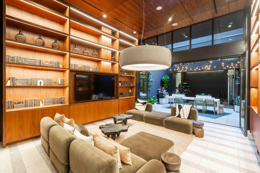 a living room filled with furniture and a large screen tv