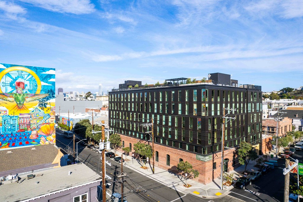 a large mural on the side of a building on a city street