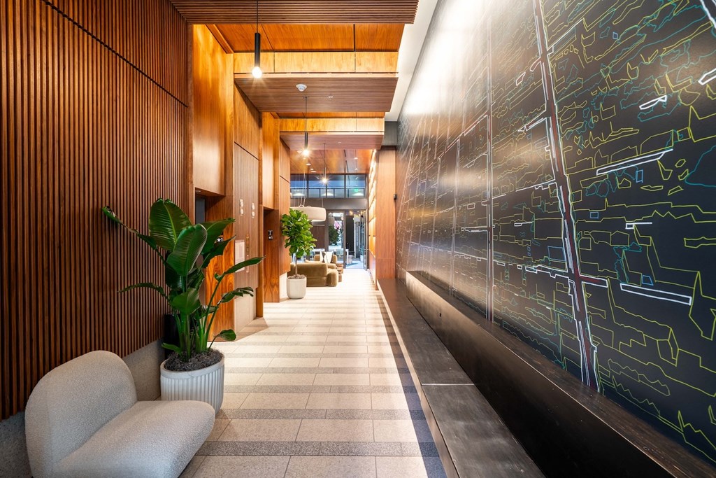 the lobby or reception area of a building with a black wall with equations on it
