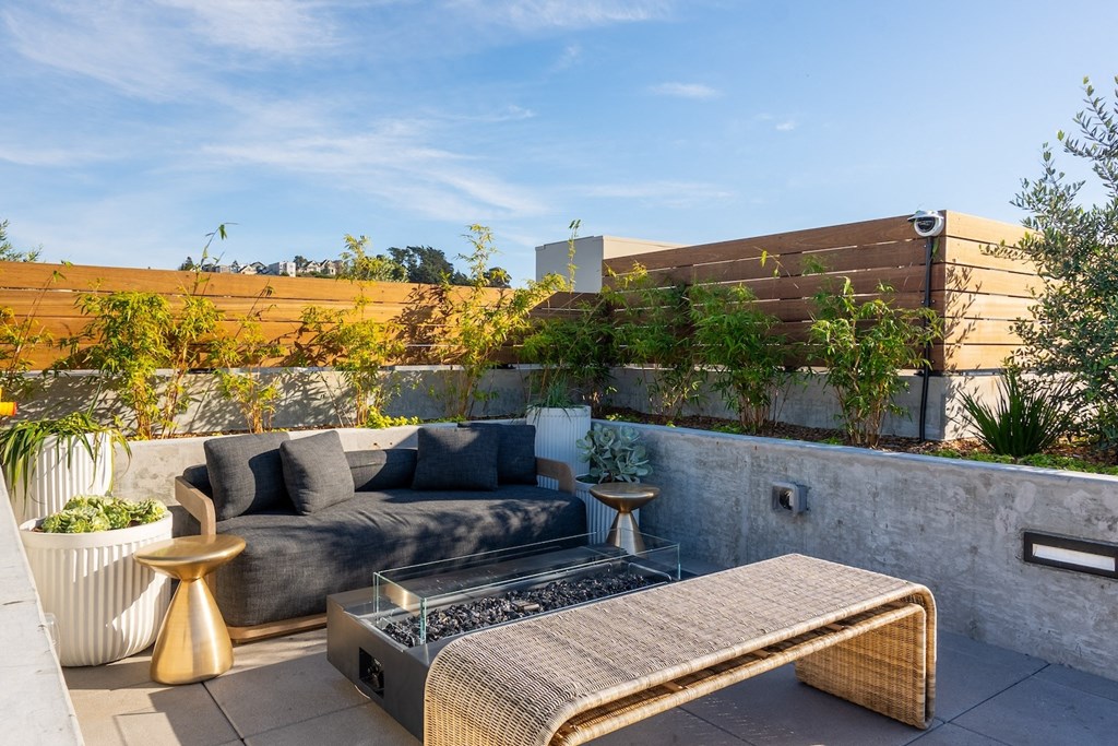 a living area with a couch and a coffee table on a patio