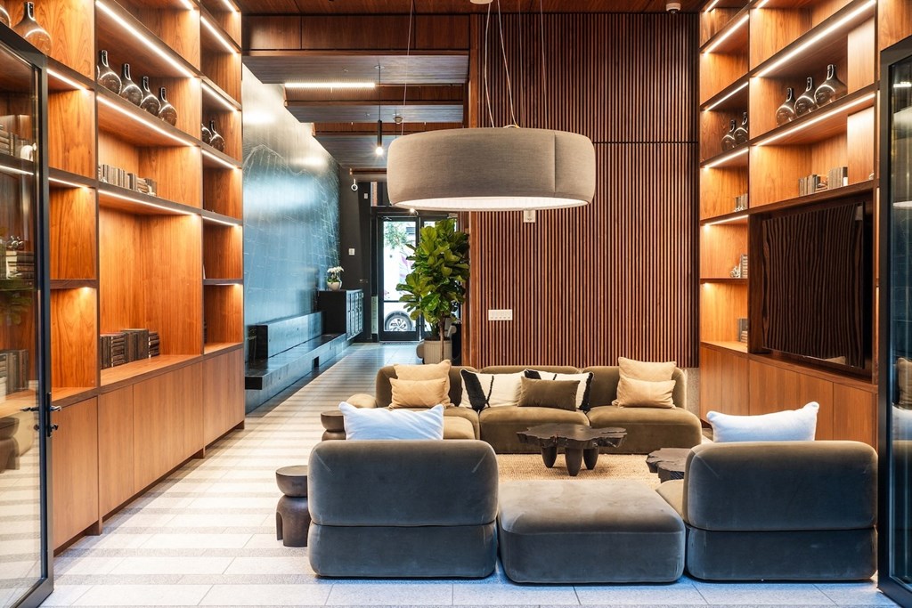 a lobby with couches and chairs and wooden walls