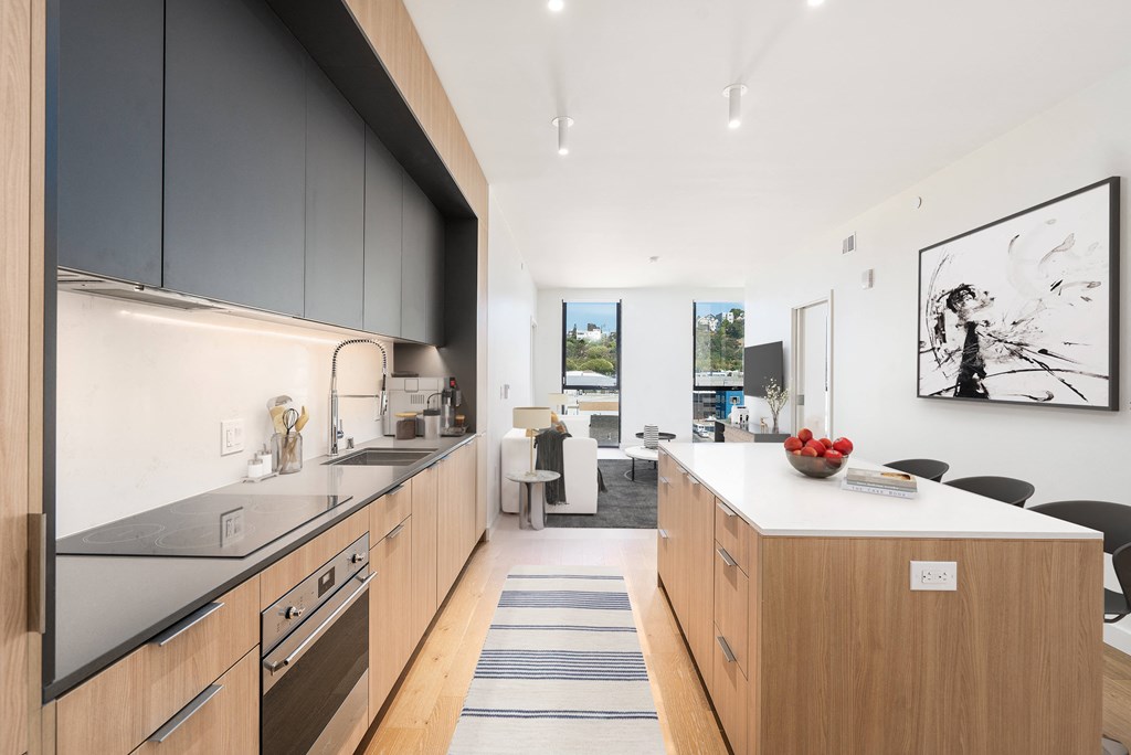 a kitchen with wooden cabinets and a white counter top