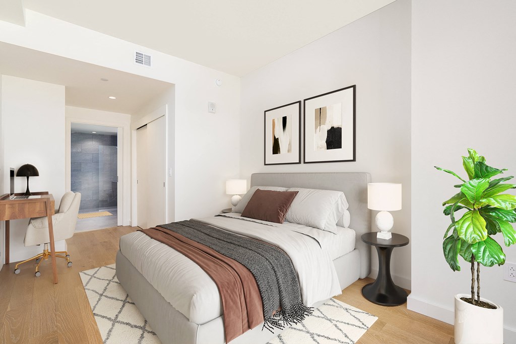 a bedroom with a bed and desk in a 555 waverly unit