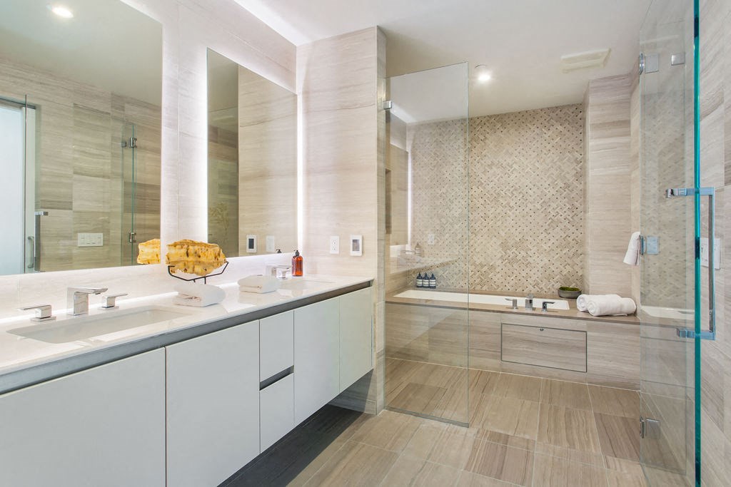 a bathroom with a shower and a sink and a mirror