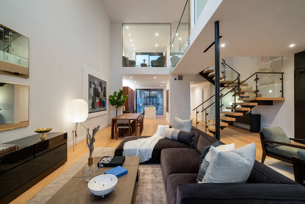 a living room with a couch and a staircase