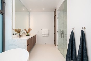 Custom walnut vanities with Calacatta-honed
marble countertops - Photo Gallery 6