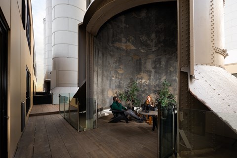 two people sitting on a bench in the lobby of a building
