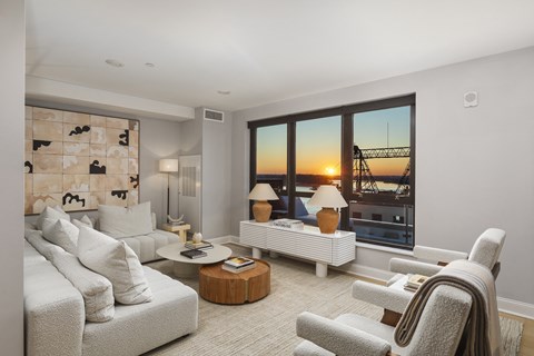 the living room has a view of the city and the bay from the window