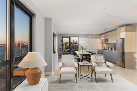 a living room with a view of a kitchen and a dining room