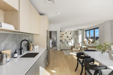 a kitchen and living room with a view of a living room