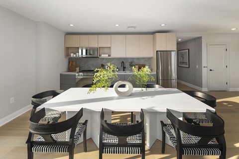 a kitchen and dining room with a white table and chairs
