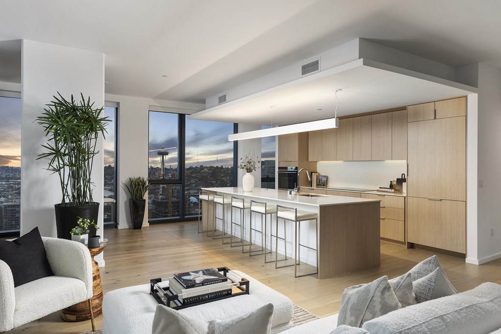 an open floorplan living room and kitchen with a view of the city