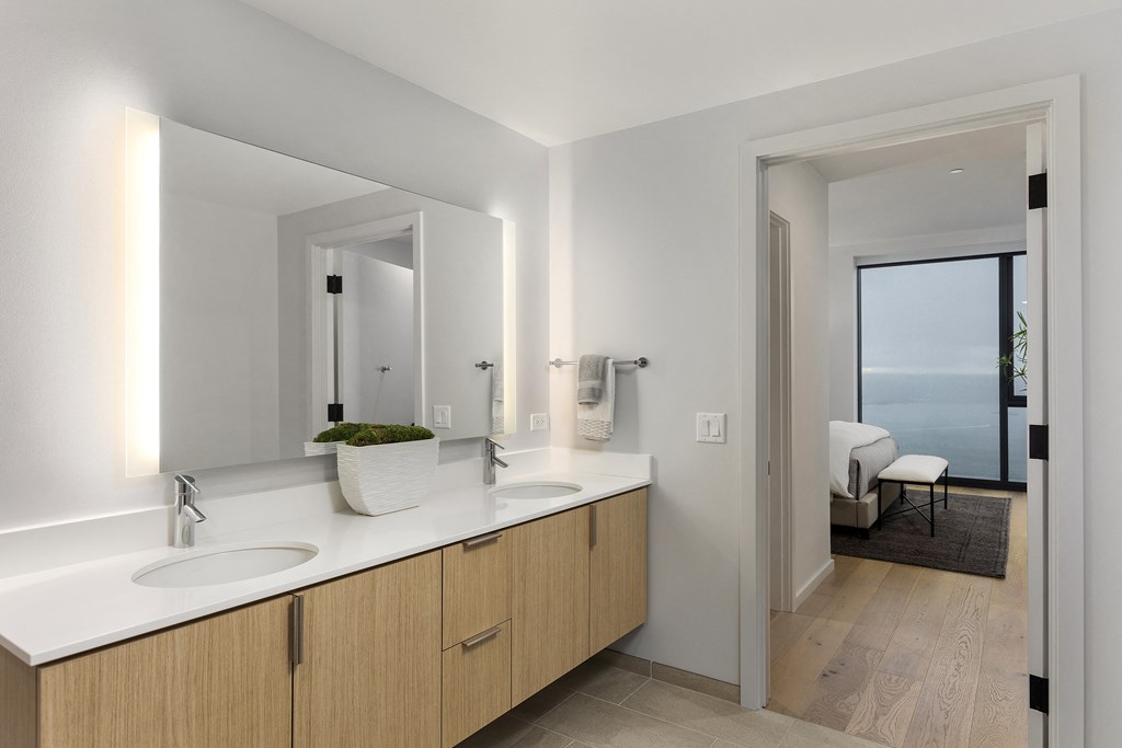 a bathroom with two sinks and a large mirror