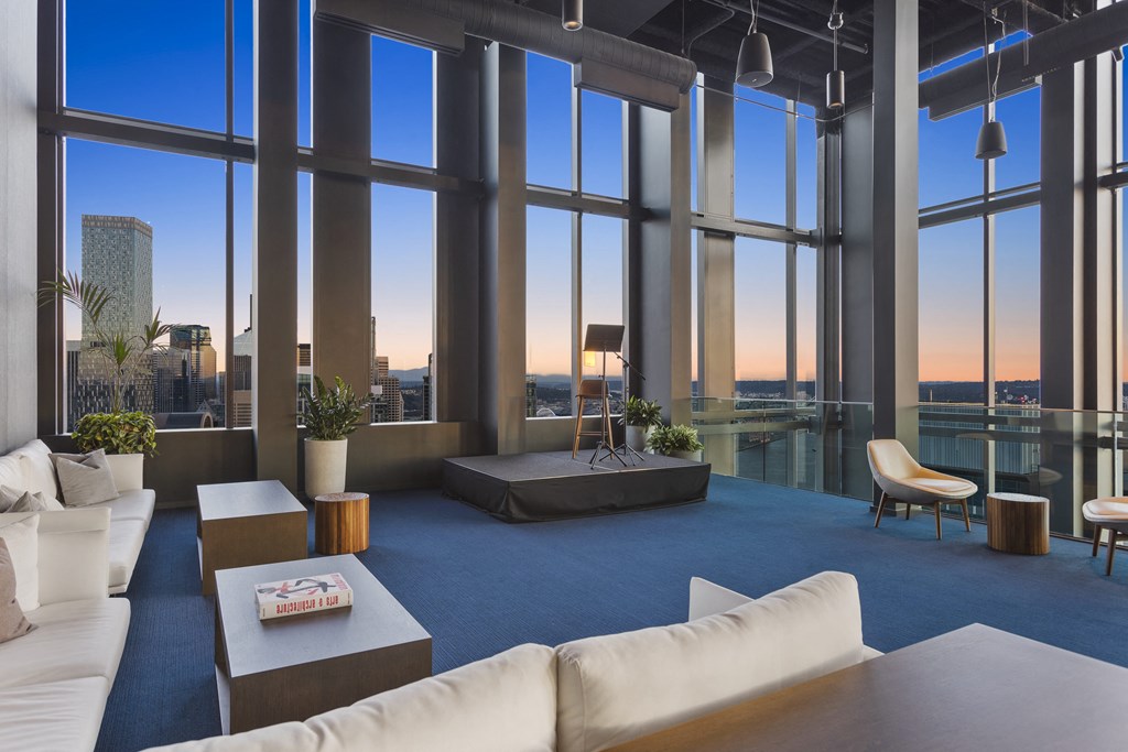 an open living room with a view of the city