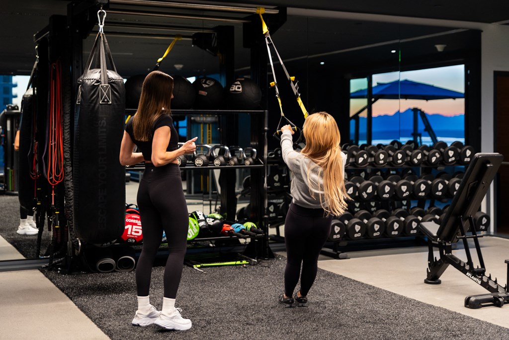 two women working out in a gym with weights
