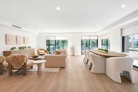 A modern living room with a long white couch and a wooden coffee table.