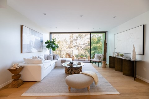 a living room with a white couch and a large window
