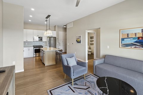 A modern kitchen with a dining area and a living room.