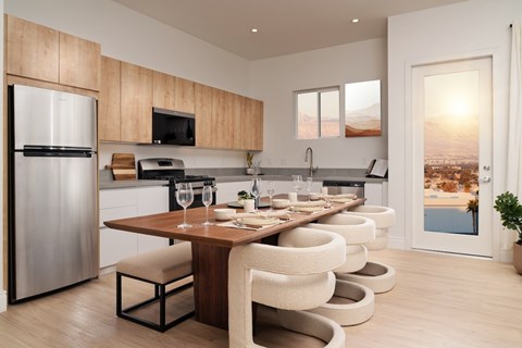 A modern kitchen with a dining table and chairs.
