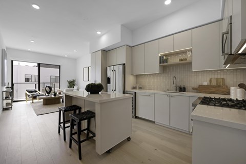 A modern kitchen with white cabinets and a large island.