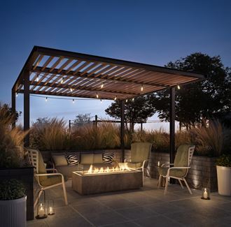 a pergola with a fire pit on the rooftop terrace