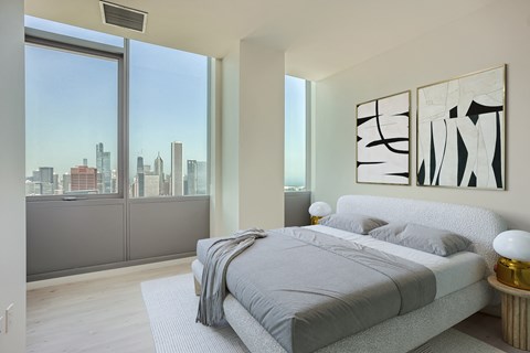 a bedroom with a bed and a view of the city