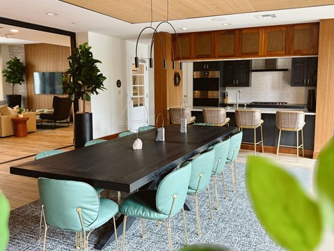 A modern dining room with a long table and chairs.