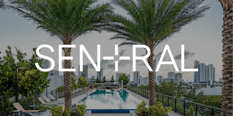 a large pool with palm trees and a city in the background