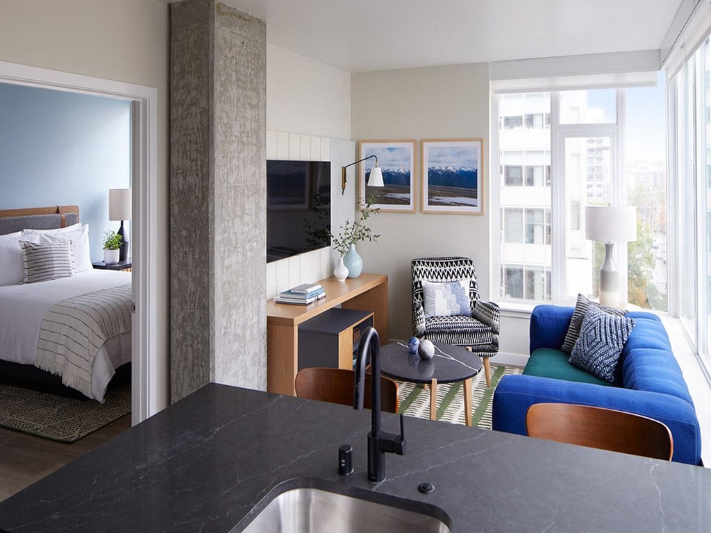 a hotel room with a view of a bed and a desk