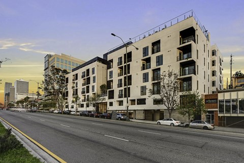 A street view of a city with cars and buildings.