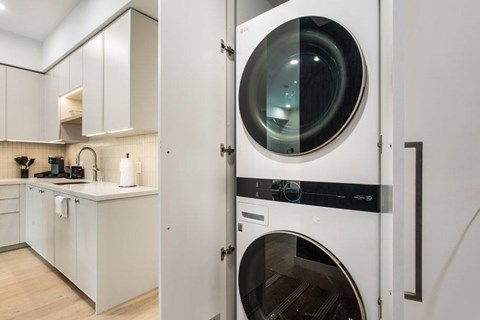 A modern kitchen and laundry area at Ten310