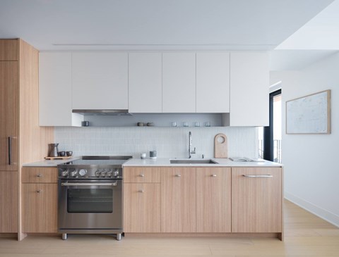 A modern kitchen with wooden cabinets and stainless steel appliances.