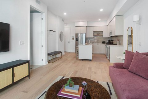 A living room with a plank flooring and natural light at Ten310