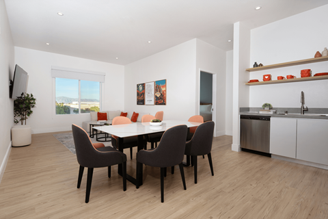 A modern dining room with a table set for six.